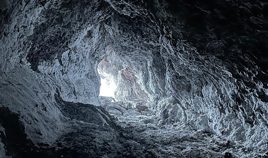 Interior del tubo de lava 'Canal Hornito Bonito', formado durante la erupci&oacute;n del Tajogaite, con dep&oacute;sitos minerales blancos que recubren parte de sus paredes. (FOTO: Nicasio Jim&eacute;nez)